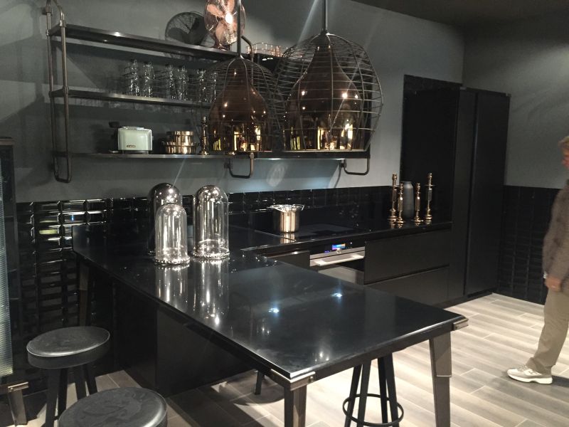 Industrial kitchen island design and black subway tiles