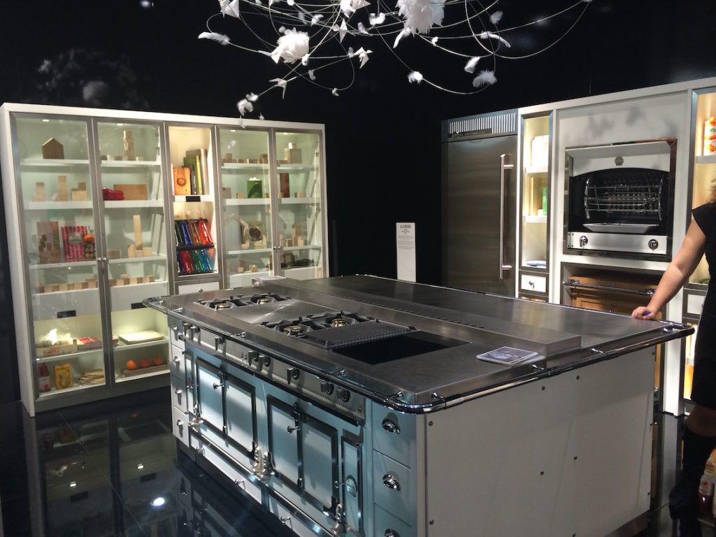 This luxe retro island with appliances is paired with modern glass-fronted storage.