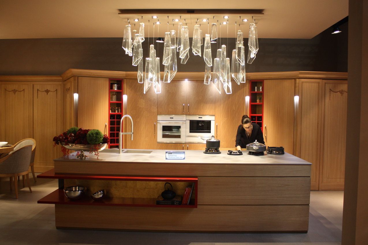 Minimal open storage and a mostly hidden kitchen make this design from Martini especially dramatic.