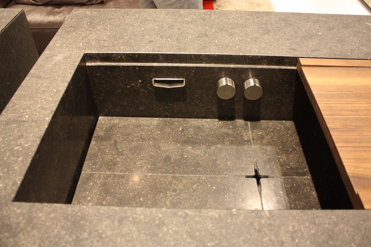 Stenninger has a sleek version where the knobs and tap are below the counter surface, and includes a sliding wood panel.