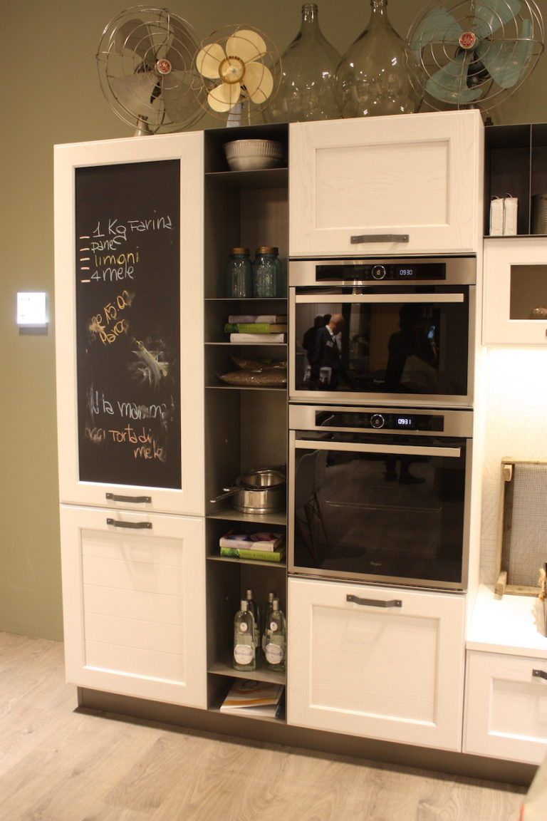 A more casual style in this Stosa kitchen includes cupboards, appliances, open shelving and a chalkboard.