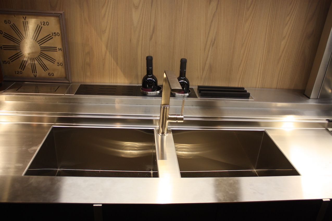 A double sink can have a faucet installed in the center divider. This one is by Valdesign.